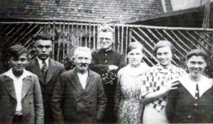 Alfred Delp in happier times.  With his parents and siblings in the early 1930s.  Delp's parents are on either side of him.